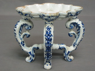 An 18th/19th Century shaped blue and white candle stand, raised on 4 globular supports 7"