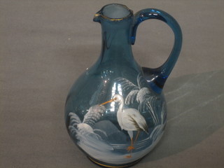A Victorian blue glass ewer with enamelled stork decoration (chip to rim) 6"