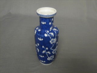 An Oriental blue and white club shaped vase with prunus decoration, the base with 4 character figure mark 10"