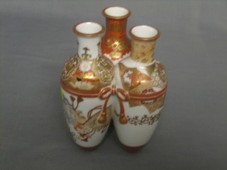 An Oriental porcelain vase in the from of 3 grouped club shaped vases tied with ribbon, decorated birds, 8" (f and cracked)