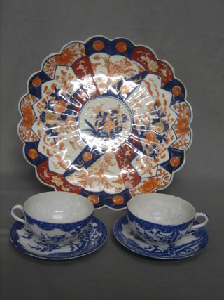A circular Japanese Imari porcelain plate with lobed border and floral decoration 12" and 2 late Japanese blue and white egg shell porcelain cups and saucers
