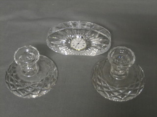 A Waterford cut glass timepiece 5" and 2 circular stub glass candlesticks 4"