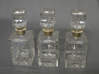 3 cut glass spirit decanters and stoppers with silver collars