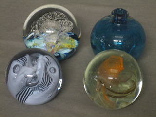 A Selkirk Glass paperweight, a Caithness snowtrail paperweight, an Isle of Wight glass paperweight and a small vase