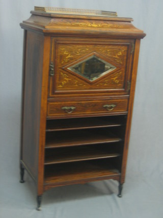 A Victorian inlaid rosewood music cabinet the top with brass three-quarter gallery, the base fitted a cupboard enclosed by a panelled door above 1 long drawer, the base fitted 4 shelves, raised on turned supports 22"