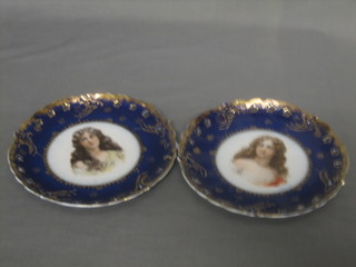 A pair of 19th Century circular Continental porcelain plates with blue and gilt banding, the centres decorated portraits of girls 8 1/2"