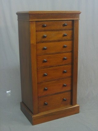 A Victorian walnut Wellington chest of 7 long drawers with tore handles, raised on a platform base 22"