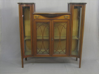 An Edwardian inlaid mahogany chiffonier the centre section fitted a drawer above a cupboard enclosed by astragal glazed panelled doors, raised on square tapering supports 48"