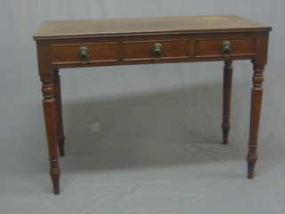 A 19th Century mahogany side table fitted 3 short drawers with lion mask drop handles, raised on turned supports 41"