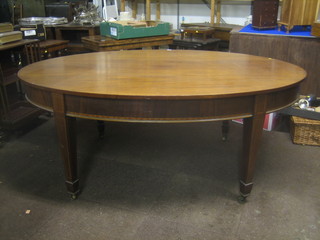 An Edwardian Georgian style oval dining table raised on square tapering supports ending in spade feet 72"