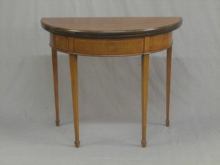 An Edwardian Georgian style inlaid mahogany demi-lune card table, raised on square tapering supports ending in spade feet 36"