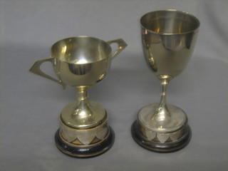 A silver plated twin handled trophy cup and a goblet shaped trophy cup