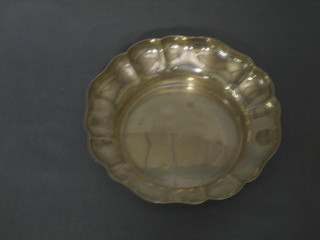 A circular modern silver dish with wavy border 4"