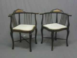 A pair of Edwardian inlaid mahogany corner chairs inlaid with ebony raised on cabriole supports