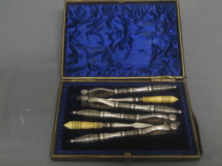 2 pairs of Victorian silver plated nut crackers and a pair of nut picks, contained in a leather case
