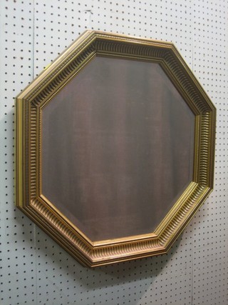 An octagonal bevelled plate wall mirror contained in a gilt frame 24"