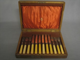 A set of 6 silver plated fruit knives and forks by Mappin & Webb contained in an oak canteen box