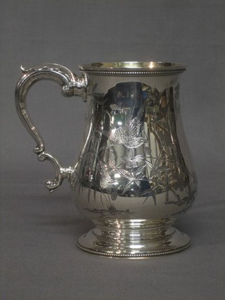 A handsome Victorian baluster shaped silver pint tankard engraved birds amidst branches, raised on a circular spreading foot, London 1879, 12 ozs