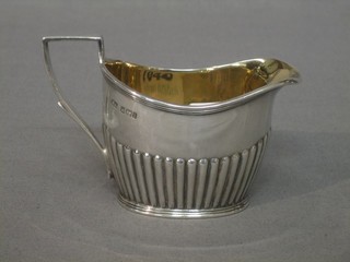 An oval silver cream jug with demi reeded decoration, Sheffield 1903, 3 ozs