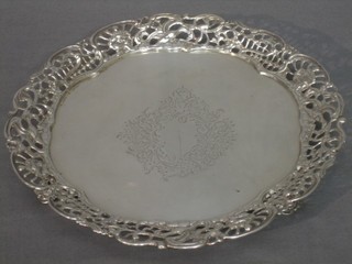 A Victorian silver circular salver with pierced border, raised on 3 panelled supports London 1857, 12 ozs