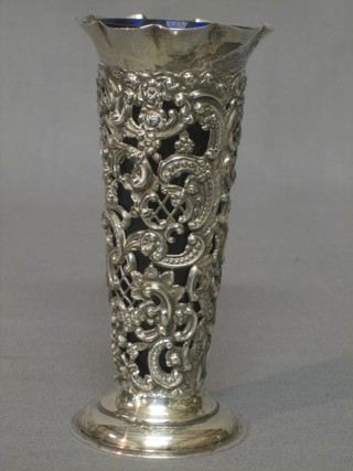A Victorian pierced silver tapering vase raised on a circular spreading foot, complete with blue glass liner, London 1895 5"