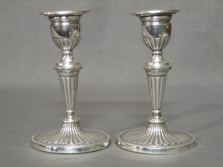 A pair of Danish sterling candlesticks with reeded decoration, the bases marked SVT Sterling Denmark 925S, 7"
