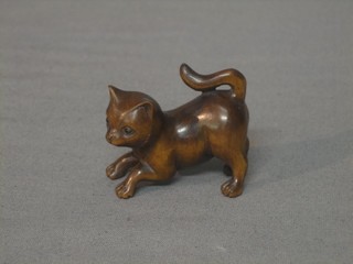 A reproduction carved wooden Netsuke in the form of a cat 2"