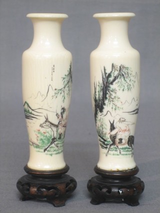 2 Eastern carved ivory vases decorated horsemen 4", raised on turned wooden bases