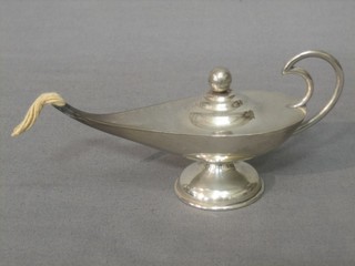 A silver plated table lighter in the form of an Eastern lamp