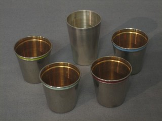 4 spirit measures with enamelled rims marked Germany and a Continental silver spirit measure marked 800