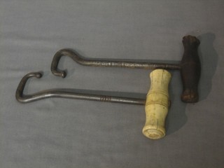 A 19th Century steel and bone boot hook together with 1 other