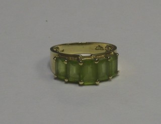 A 14ct gold dress ring set rectangular cut peridots