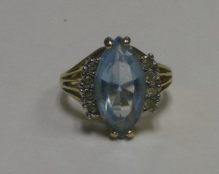 A 18ct yellow gold dress ring set a boat shaped aquamarine and supported by diamonds