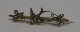 A 9ct gold bar brooch in the form of a dove set demi pearls