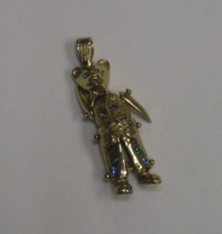 A gilt metal charm in the form of a teddybear set precious stones
