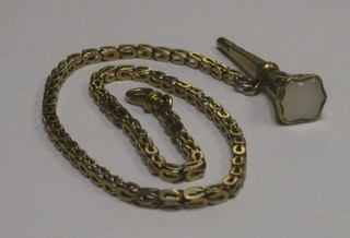 A gilt metal watch chain hung a gilt metal key