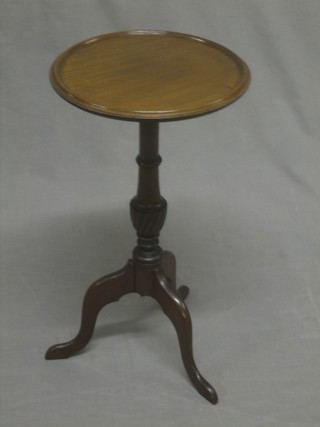 A circular mahogany Georgian style wine table, raised on pillar and tripod supports 12"