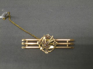 An Edwardian 9ct gold bar brooch in the form of a dove set demi-pearls 