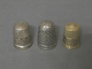 A gilt metal thimble and 2 silver thimbles