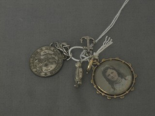 A gilt metal double sided photograph locket, a silver charm in the form of an anchor, do. teddybear and a St Christopher medal 