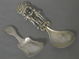 A Continental silver caddy spoon decorated Adam & Eve, a Continental caddy spoon and a do. sifter spoon (f)