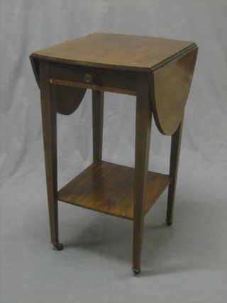 An Edwardian inlaid mahogany oval drop flap occasional table, fitted a drawer with undertier, raised on square tapering supports 15"