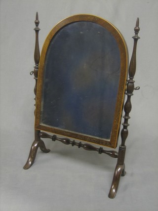 A 19th Century arch plate dressing table mirror contained in a mahogany swing frame