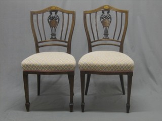 A pair of Edwardian Sheraton style inlaid mahogany slat back dining chairs with upholstered seats
