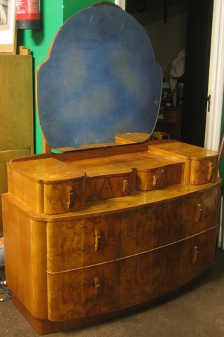 An Art Deco walnut dressing chest with shaped mirror to back, the base fitted 4 short drawers above 2 long drawers 46"