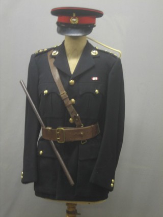 A Royal Marine Fleet Volunteer Reserve Lieutenant's dress uniform comprising tunic, peaked cap with 2 covers, Sam Brown belt, trousers, boots, a pair of service shoes and a  swagger stick by Moss Bros & Co, Covent Garden London