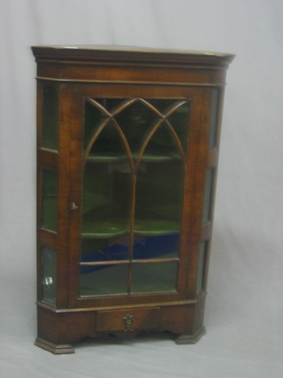 A Queen Anne style walnut corner cabinet fitted shelves enclosed by astragal glazed panelled door, the base fitted 1 long drawer, raised on ogee bracket feet 23"