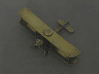 A brass Trench Art model bi-plane with RFC button 5 1/2"