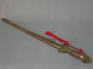 A reproduction Oriental sword the blade signed complete with hardwood scabbard