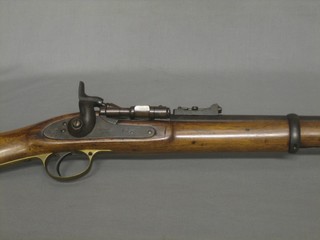 A 19th Century breach loading BSA rifle, the lock with crowned Royal Cypher marked BSA 1866, the stock impressed RM Enfield complete with metal cleaning rod